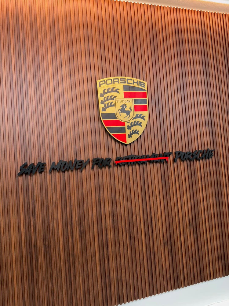 Stuttgart crest with Black letters save money for retirement Porsche on wooden slat wall