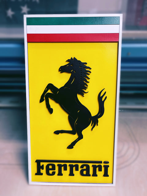 Ferrari replica emblem with green white and red stripes at the top on a yellow background with a rearing horse
