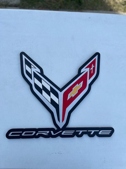 New style corvette replica emblem painted in like colors with words below