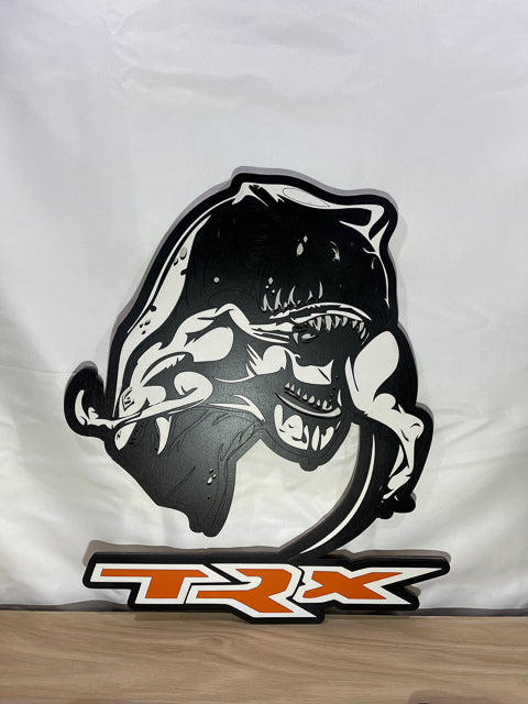 A TRX eating a Raptor in black and white with TRX in Orange